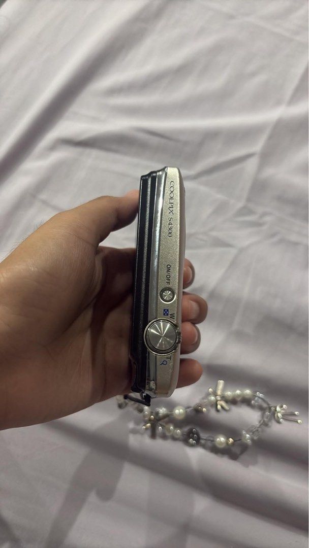 Nikon Coolpix S4300 Digital Camera (Category: Cameras) located in San Pedro. Submitted by jowiosabel (Listing ID 1455328696, Image 2). Description: Nikon Coolpix S4300 digital camera - Good condition (All working) - Compact point-and-shoot style - Touchscreen - Comes with a cute beaded wrist strap - Includes a small pouch - Battery charger included - Minor vignette on screen but does not affect the quality - Ideal for everyday, casual photography