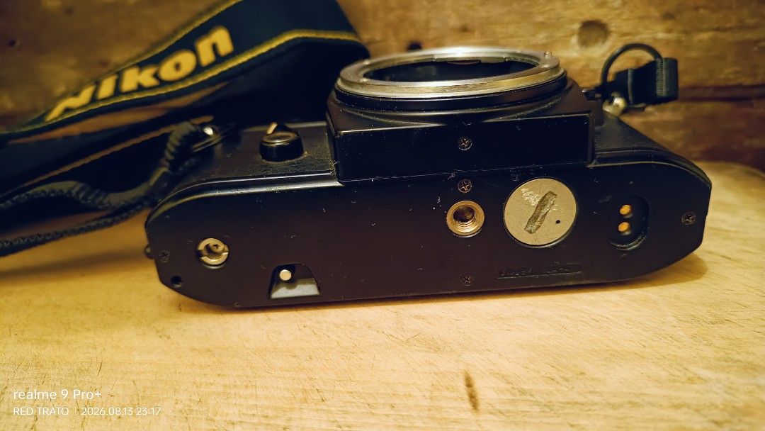 💯 Nikon EM Film Camera Blue Button with Nikon Strap (Category: Cameras) located in General Mariano Alvarez. Submitted by randzwurkz85264 (Listing ID 1455472820, Image 3). Description: - Nikon EM film camera - Blue button series - Clean smooth body - Includes original Nikon strap - Lens mount visible - Camera interior shown - Perfect for film photography enthusiasts - Unit, strap - Body only - Untested no battery.