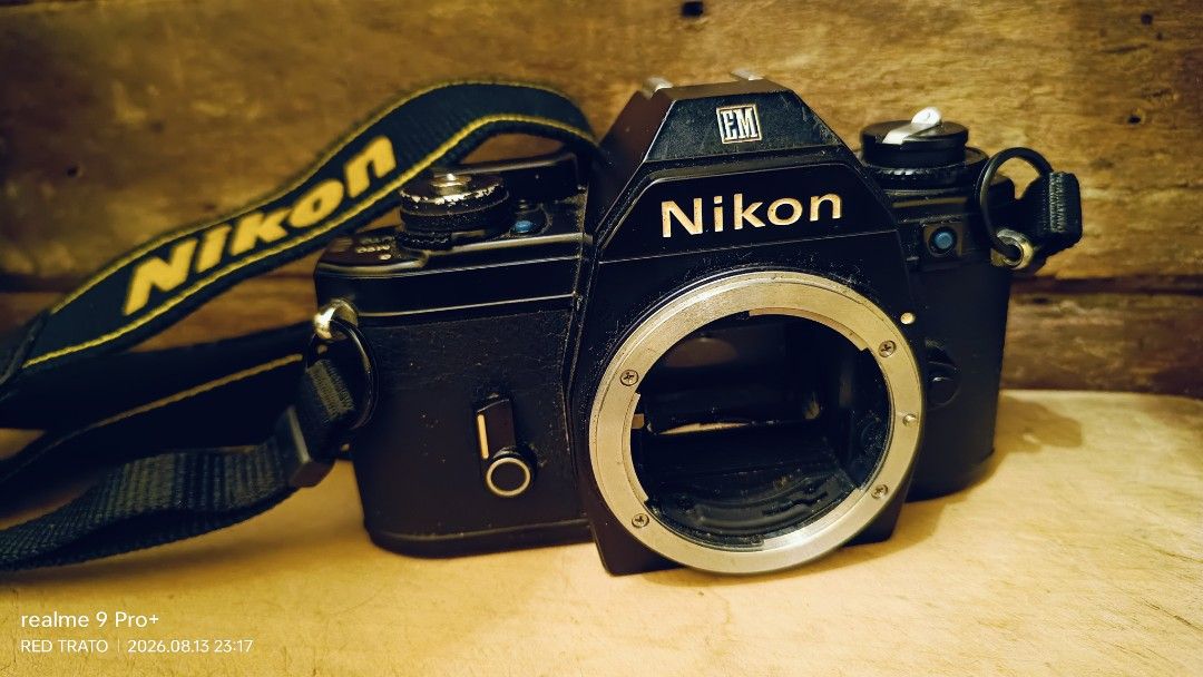 💯 Nikon EM Film Camera Blue Button with Nikon Strap (Category: Cameras) located in General Mariano Alvarez. Submitted by randzwurkz85264 (Listing ID 1455472820, Image 1). Description: - Nikon EM film camera - Blue button series - Clean smooth body - Includes original Nikon strap - Lens mount visible - Camera interior shown - Perfect for film photography enthusiasts - Unit, strap - Body only - Untested no battery.