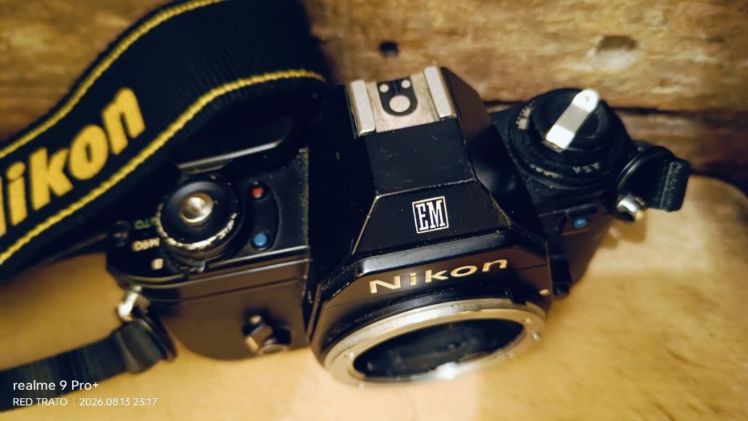 💯 Nikon EM Film Camera Blue Button with Nikon Strap (Category: Cameras) located in General Mariano Alvarez. Submitted by randzwurkz85264 (Listing ID 1455472820, Image 2). Description: - Nikon EM film camera - Blue button series - Clean smooth body - Includes original Nikon strap - Lens mount visible - Camera interior shown - Perfect for film photography enthusiasts - Unit, strap - Body only - Untested no battery.
