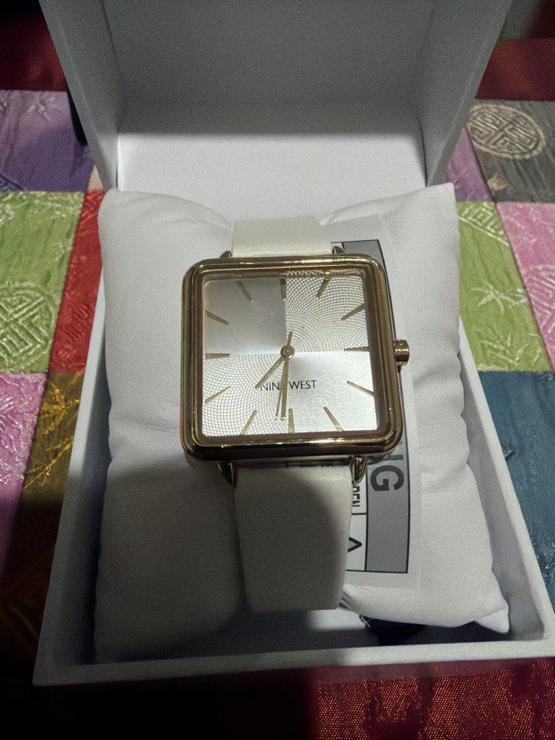 Nine West Square Face Watch White Strap Gold Tone (Category: Women's Watches) located in Makati City. Submitted by eric103 (Listing ID 1455427361, Image 2). Description: - Nine West watch - Square gold-tone face - White strap - Includes original box - Ideal for everyday or special occasions - Simple and classic design.