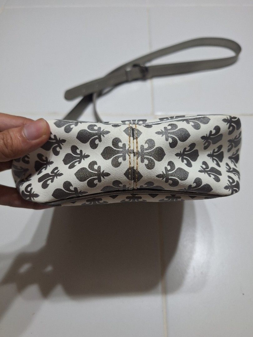 Patrick Cox White and Grey Fleur-de-lis Pattern Crossbody Bag (Category: Cross-body Bags) located in Las Pinas. Submitted by second.founds (Listing ID 1455398247, Image 3). Description: Patrick Cox sling bag -6 inches by 8.5 inches Strap - 57 inches -What you see is what you get. -Lightly used -Mop: gcash / bdo -courier: ggx - Stylish white crossbody bag - Features a grey fleur-de-lis pattern - Adjustable grey strap for comfortable wear - Secure 