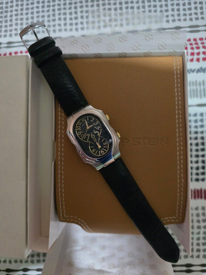Philip Stein Dual Time Watch with Extra Strap (Category: Women's Watches) located in Las Pinas. Submitted by luxeprelovedstuff (Listing ID 1455387287, Image 1). Description: - Authentic Philip Stein Dual Time Watch - Elegant black dial with gold accents - Water Resistant 3 ATM - Features Natural Frequency Technology - Comes with original box and tan wallet - Includes an extra white strap - Serial Number: 2TF174303.
