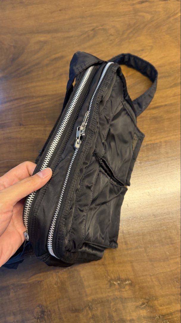 Porter Yoshida & Co. Black Nylon Messenger Bag (Category: Sling Bags) located in San Fernando. Submitted by enzorod (Listing ID 1455368406, Image 2). Description: - Classic black messenger bag by Porter Yoshida & Co. - Made from durable nylon material. - Features multiple front pockets for easy access. - Adjustable strap for comfortable carrying. - Smooth and fully functional zippers. - Spacious interior, ideal for daily essentials or travel item