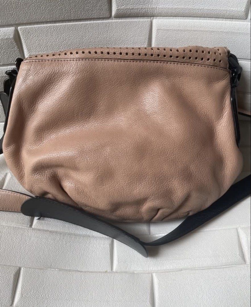 Rare Marc Jacobs Perforated Leather Crossbody Bag (Category: Luxury Bags & Wallets) located in Cebu City. Submitted by lucypim (Listing ID 1455441699, Image 3). Description: - Rare Marc Jacobs crossbody bag - Authentic -Genuine leather material - Medium size, lightweight, and spacious - Unique and hard-to-find item.