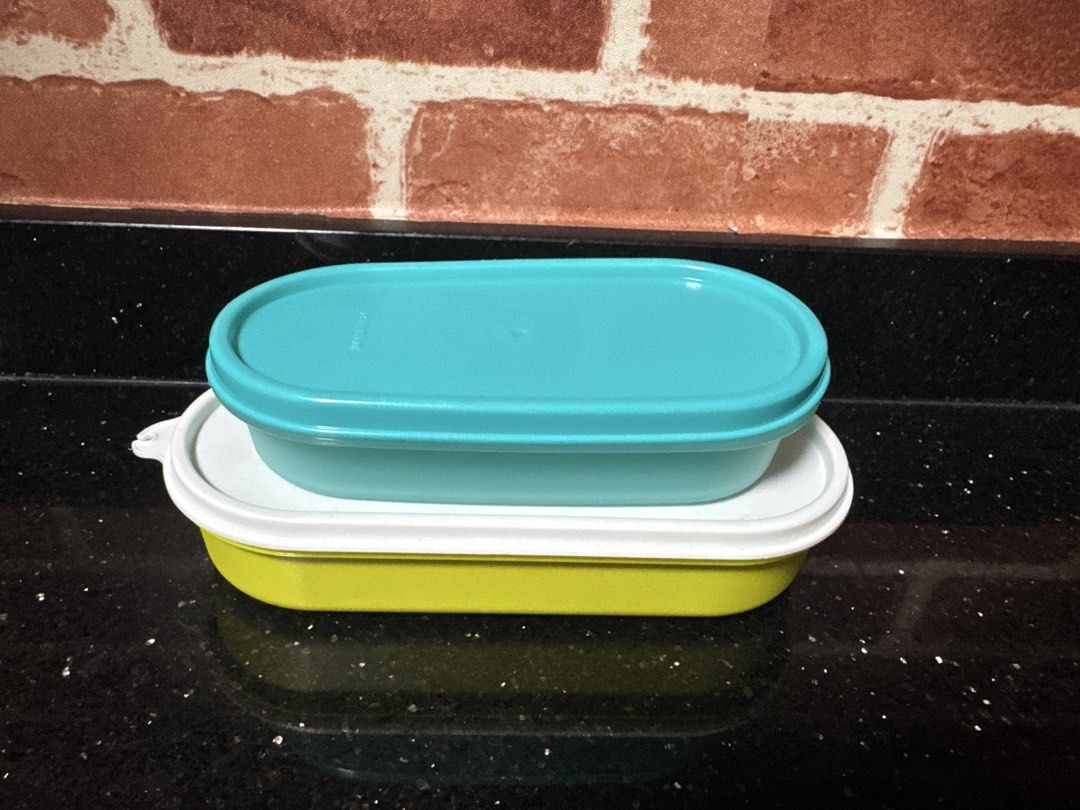 Rectangular Tupperware containers (Category: Food Organisation & Storage) located in Singapore. Submitted by rejoice7 (Listing ID 1455488722, Image 1). Description: Selling a matching set of TWO (2) authentic, genuine rectangular Tupperware storage containers. Their flat, straight-edge rectangular design makes them perfect space-savers because they line up and stack beautifully together inside your fridge, freezer, or pantry cabinets! Features:Se