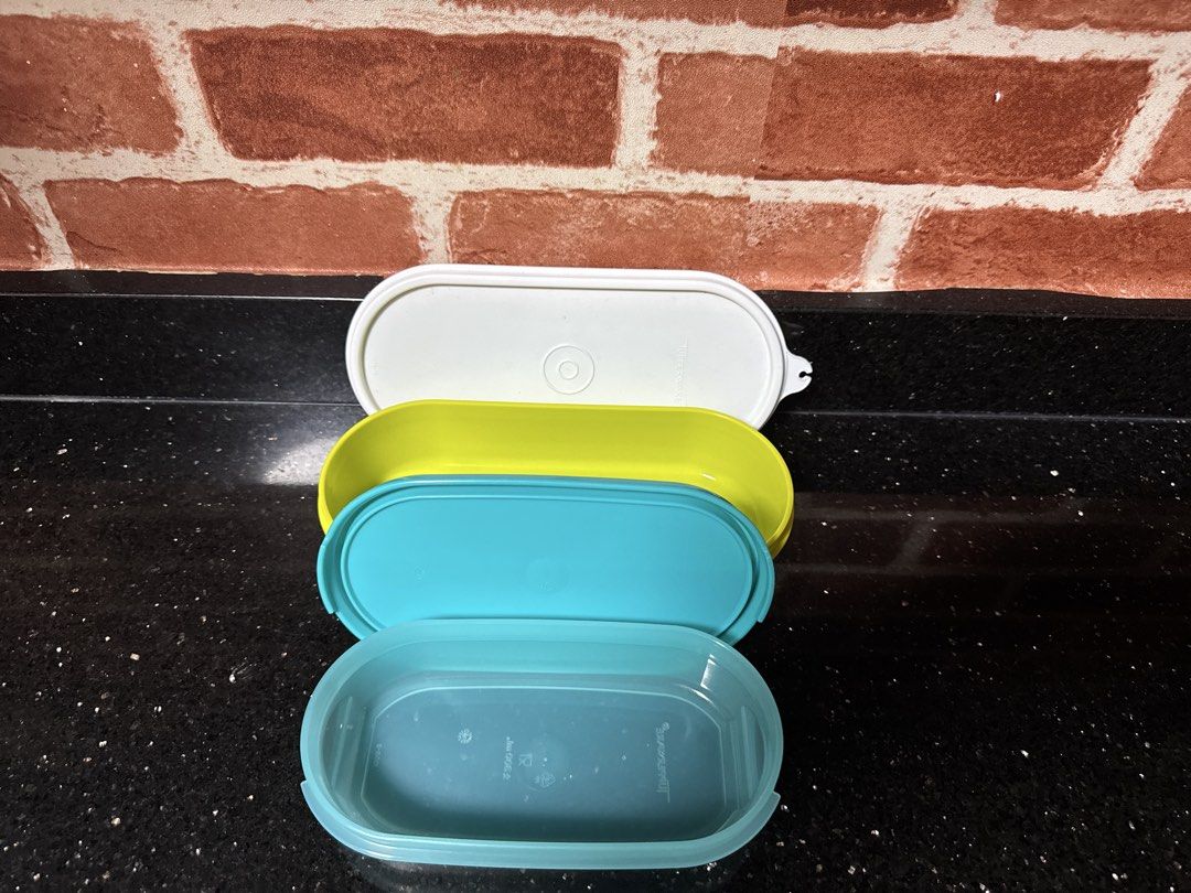 Rectangular Tupperware containers (Category: Food Organisation & Storage) located in Singapore. Submitted by rejoice7 (Listing ID 1455488722, Image 2). Description: Selling a matching set of TWO (2) authentic, genuine rectangular Tupperware storage containers. Their flat, straight-edge rectangular design makes them perfect space-savers because they line up and stack beautifully together inside your fridge, freezer, or pantry cabinets! Features:Se