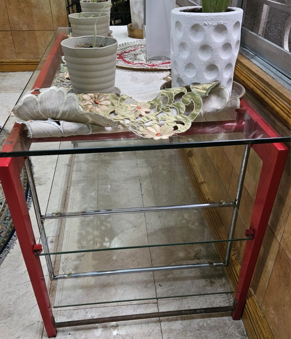Red Metal Frame Glass Top Console Table with Shelves (Category: Tables & Sets) located in Las Pinas. Submitted by elynanne24 (Listing ID 1455416852, Image 3). Description: Center table for sale for only P3500.00 Tempered glass top Tempered glass shelves Metal and wooden frame For pick-up only If for shipping, vuyer will pay for the fee Location: Village near Las Piñas Doctors Hospital Thank you and God bless. .