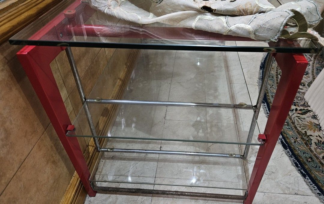 Red Metal Frame Glass Top Console Table with Shelves (Category: Tables & Sets) located in Las Pinas. Submitted by elynanne24 (Listing ID 1455416852, Image 1). Description: Center table for sale for only P3500.00 Tempered glass top Tempered glass shelves Metal and wooden frame For pick-up only If for shipping, vuyer will pay for the fee Location: Village near Las Piñas Doctors Hospital Thank you and God bless. .