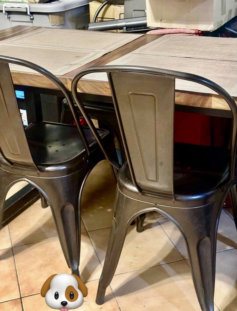 Rustic Dining Table with Metal Chairs (Category: Tables & Sets) located in Manila. Submitted by gboi1982 (Listing ID 1455385997, Image 1). Description: - Natural wood grain dining table (solid Acacia) - Includes 4 dark metal chairs with industrial design - Ideal for small dining areas or kitchens - Easy to clean and maintain - Versatile for daily use and entertaining.