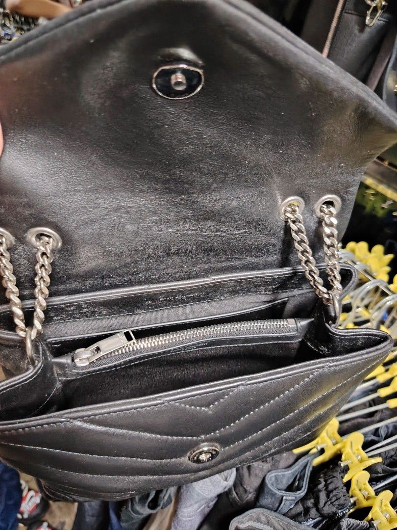 Saint Laurent Black Leather Chevron Flap Bag (Category: Luxury Bags & Wallets) located in Baguio. Submitted by XycerlynCLXN (Listing ID 1455323805, Image 3). Description: - Black Saint Laurent Flap Bag - Signature chevron quilting - Silver chain strap - Interior zip pocket - Embossed 'Saint Laurent Paris' on leather strap - A timeless and stylish accessory.