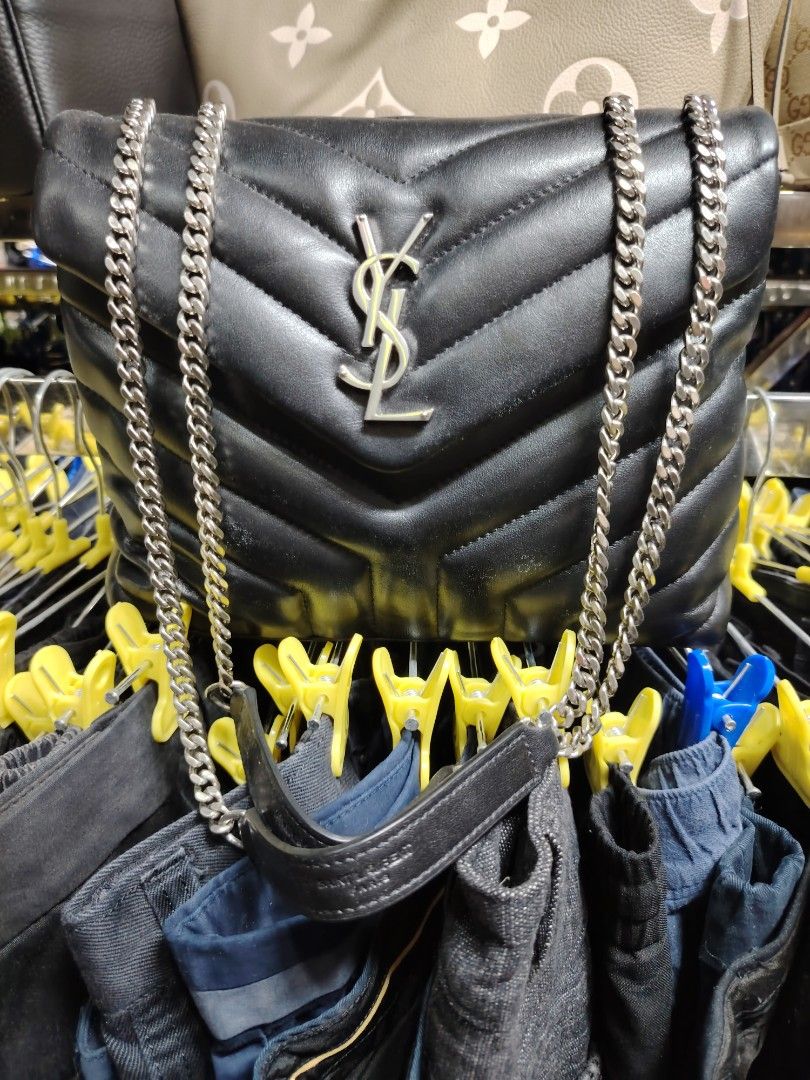Saint Laurent Black Leather Chevron Flap Bag (Category: Luxury Bags & Wallets) located in Baguio. Submitted by XycerlynCLXN (Listing ID 1455323805, Image 1). Description: - Black Saint Laurent Flap Bag - Signature chevron quilting - Silver chain strap - Interior zip pocket - Embossed 'Saint Laurent Paris' on leather strap - A timeless and stylish accessory.