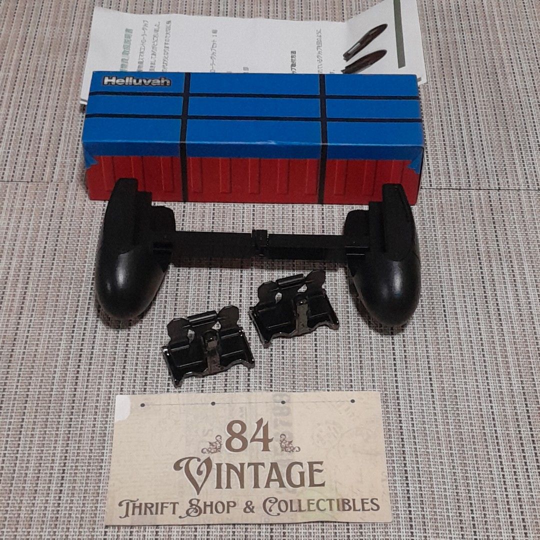 Smartphone Controller Grip Set (Category: Controllers) located in Las Pinas. Submitted by 84vintage (Listing ID 1455429427, Image 2). Description: ⚠️5 pieces available⚠️ Mobile gaming controller grip set with physical clip-on triggers and an ergonomic handle design Actual photos posted. Please examine them carefully as they are part of the description. --📌 MUST READ Before Dealing with us 📌-- ⚠️Price is posted. No lowballs please. ⚠️Vintage ite