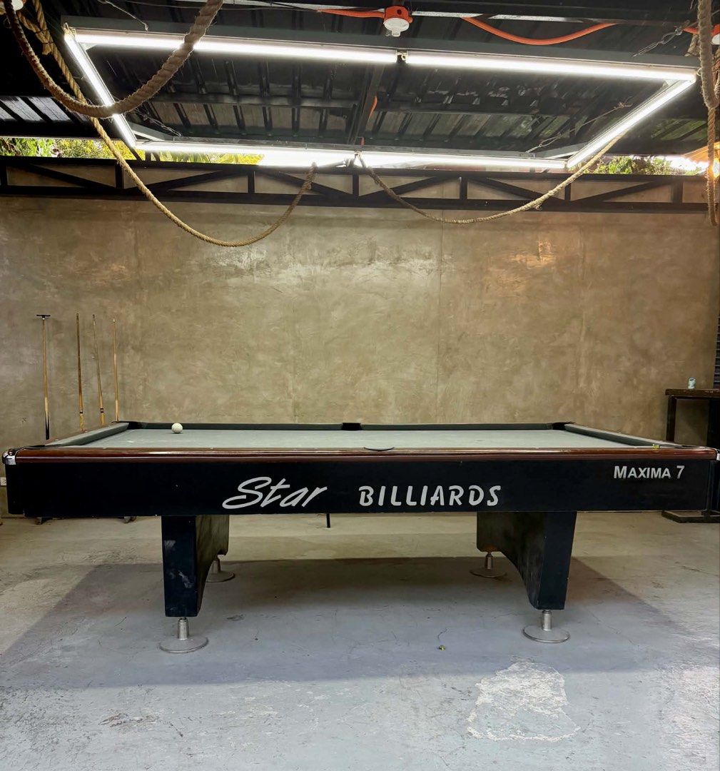 Star Billiards Maxima 7 Pool Table with Cues (Category: Billiards and Bowling) located in Manila. Submitted by miriamcfer28043 (Listing ID 1455407096, Image 2). Description: - Star Billiards Maxima 7 pool table - Includes billiard cues and balls - Grey felt playing surface - Dark brown wooden trim with minor scuffs - Ideal for game rooms or bars - Ready for pickup.