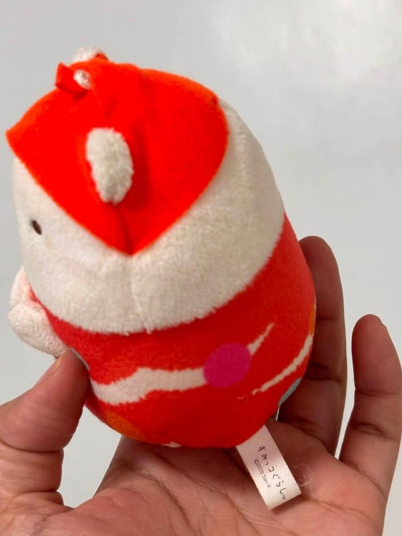 Sumikko San x plushie (Category: Plushies & Soft Toys) located in Cavite. Submitted by l1ttlelulu (Listing ID 1455474023, Image 2). Description: - Adorable round and soft plush toy - Features a cute little red hat - Red and white striped body with colorful polka dots - Includes small white hands - Approximately palm-sized - Ideal for collectors or as a small gift.