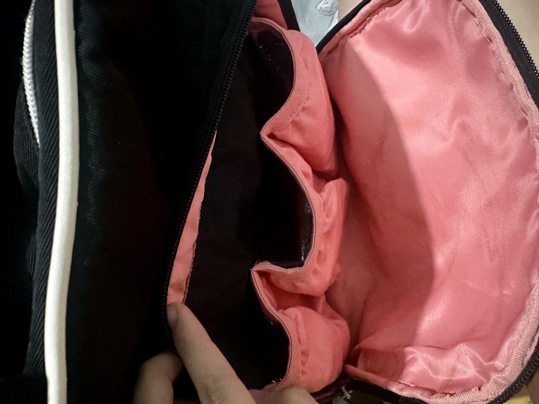 Sunveno Signature Maternity Diaper Backpack (Category: Diaper Bags & Wetbags) located in Makati City. Submitted by arkiamae (Listing ID 1455449486, Image 2). Description: - Chic black diaper backpack with white trim - Vibrant pink interior with multiple compartments and pockets - Versatile carrying options: backpack straps and top handles - Ample space for all your baby's essentials - Ideal for busy, on-the-go parents.