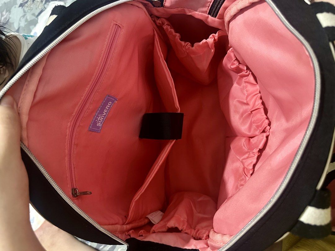 Sunveno Signature Maternity Diaper Backpack (Category: Diaper Bags & Wetbags) located in Makati City. Submitted by arkiamae (Listing ID 1455449486, Image 3). Description: - Chic black diaper backpack with white trim - Vibrant pink interior with multiple compartments and pockets - Versatile carrying options: backpack straps and top handles - Ample space for all your baby's essentials - Ideal for busy, on-the-go parents.