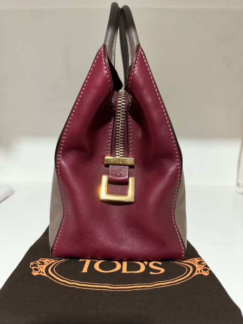 Tod's Leather Tote Bag (Category: Luxury Bags & Wallets) located in Santa Rosa. Submitted by bumfinds (Listing ID 1455437360, Image 3). Description: - Authentic Tod's leather tote bag - Stylish two-tone design: taupe and burgundy - Elegant gold hardware accents - Includes a detachable shoulder strap for versatility - Comes with original dust bag - Ideal for everyday use and carrying your essentials.