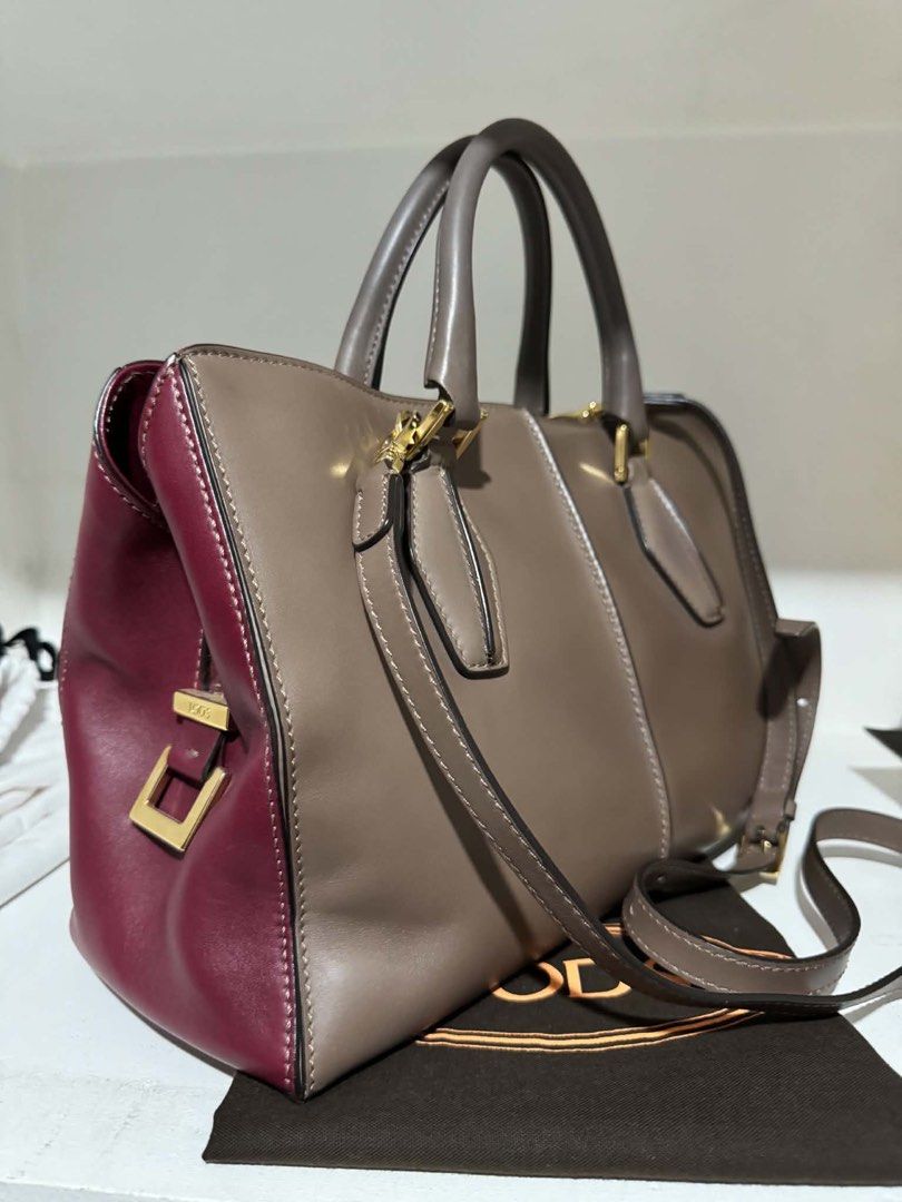 Tod's Leather Tote Bag (Category: Luxury Bags & Wallets) located in Santa Rosa. Submitted by bumfinds (Listing ID 1455437360, Image 2). Description: - Authentic Tod's leather tote bag - Stylish two-tone design: taupe and burgundy - Elegant gold hardware accents - Includes a detachable shoulder strap for versatility - Comes with original dust bag - Ideal for everyday use and carrying your essentials.