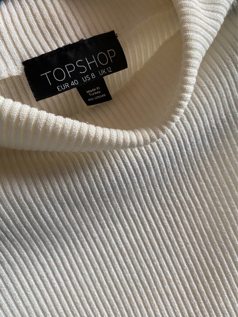 Topshop sleeveless ribbed mock-neck top (Category: Sleeveless) located in Nagcarlan. Submitted by snccollection (Listing ID 1455401648, Image 3). Description: TOPSHOP sleeveless ribbed mock-neck top in beige. Size: Large ; Worn for a few times and kept in the closet. Timeless top. RFS: doesn’t fit anymore.