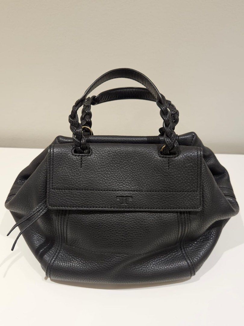 Tory Burch Half Moon Satchel – Black (Category: Luxury Bags & Wallets) located in Manila. Submitted by luckyriver.1874f0 (Listing ID 1455373978, Image 1). Description: Tory Burch Half Moon Satchel – Black Selling for ₱8,800 Original retail price: ₱25,000 Condition: 9/10 ✨ • Gently used and well-maintained • Small white marks on the front • 1 minor pen mark inside • Still has protective stickers inside • No major damage or functional issues Comes 