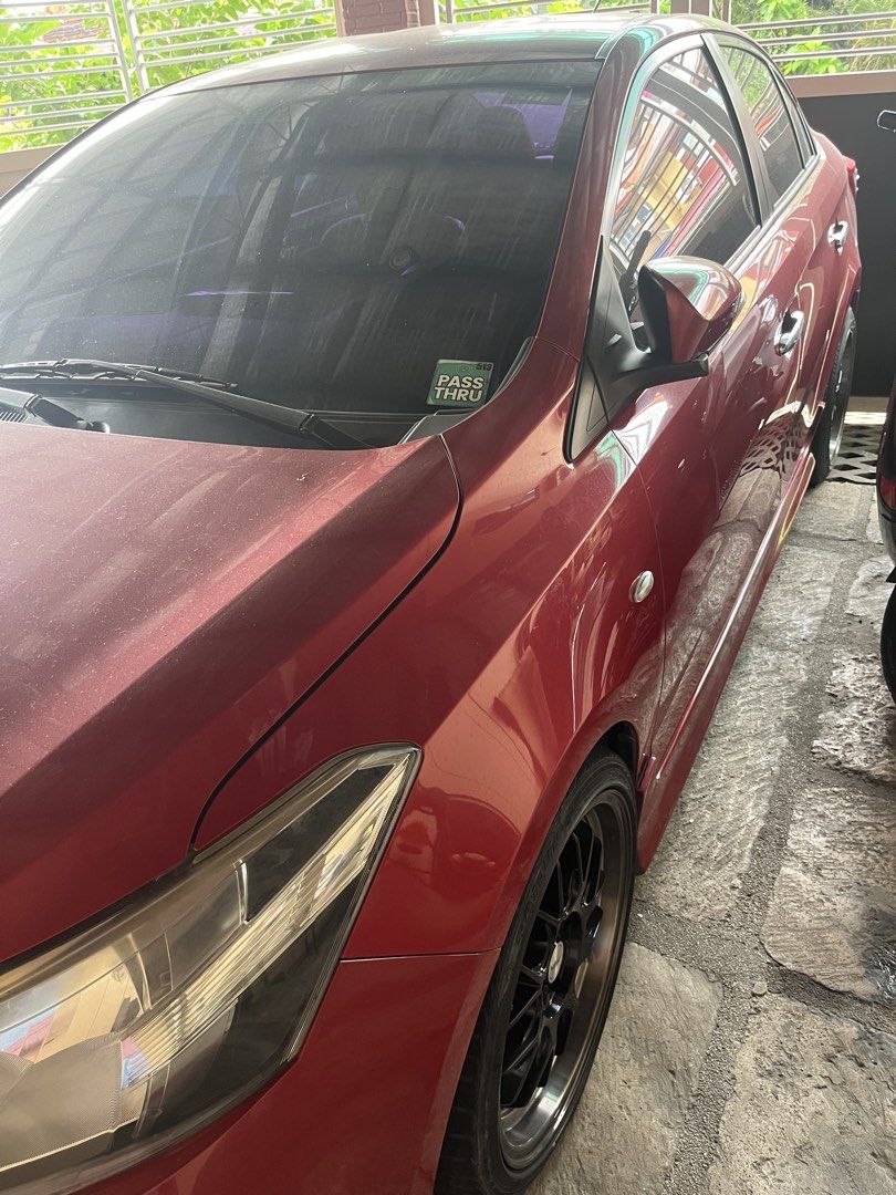 Toyota Vios 1.5 J (M) (Category: Used Cars) located in Manila. Submitted by peterlowell.tadaya (Listing ID 1455351131, Image 2). Description: Toyota vios 2014-15 1.3 J variant, manual. Looks E variant na. Modified sidelamp. Wetlook pa din dahil naka 5x ceramic coat applied from the day lumabas sa casa. Minor Hairline scratches due to usage. Pero wax and buff lang solve na. Original pain. Red mica metallic, Very good condition. Original odo meter.