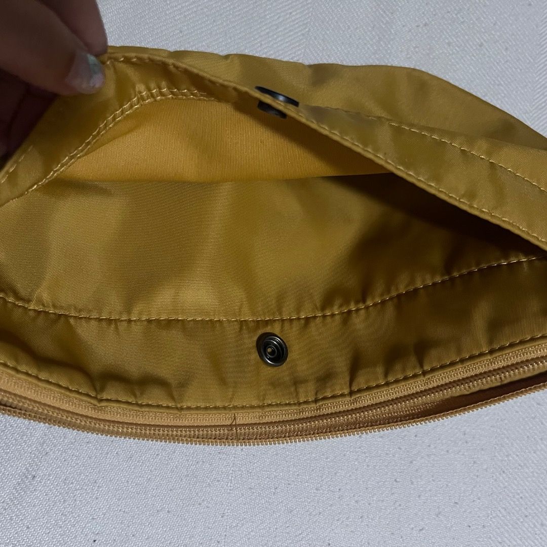 Uniqlo Nylon Mini Dumpling Sling Shoulder Bag - Yellow (Category: Cross-body Bags) located in Quezon City. Submitted by horangidee (Listing ID 1448663193, Image 3). Description: Well loved bag but still in great condition! Originally a nice yellow shade, my lighting's just horrible (feel free to ask for photos!) 💛 Nylon material, water resistant and easy to clean 💛 Adjustable straps, can make it crossbody or shoulder bag 💛 Compartments with bu