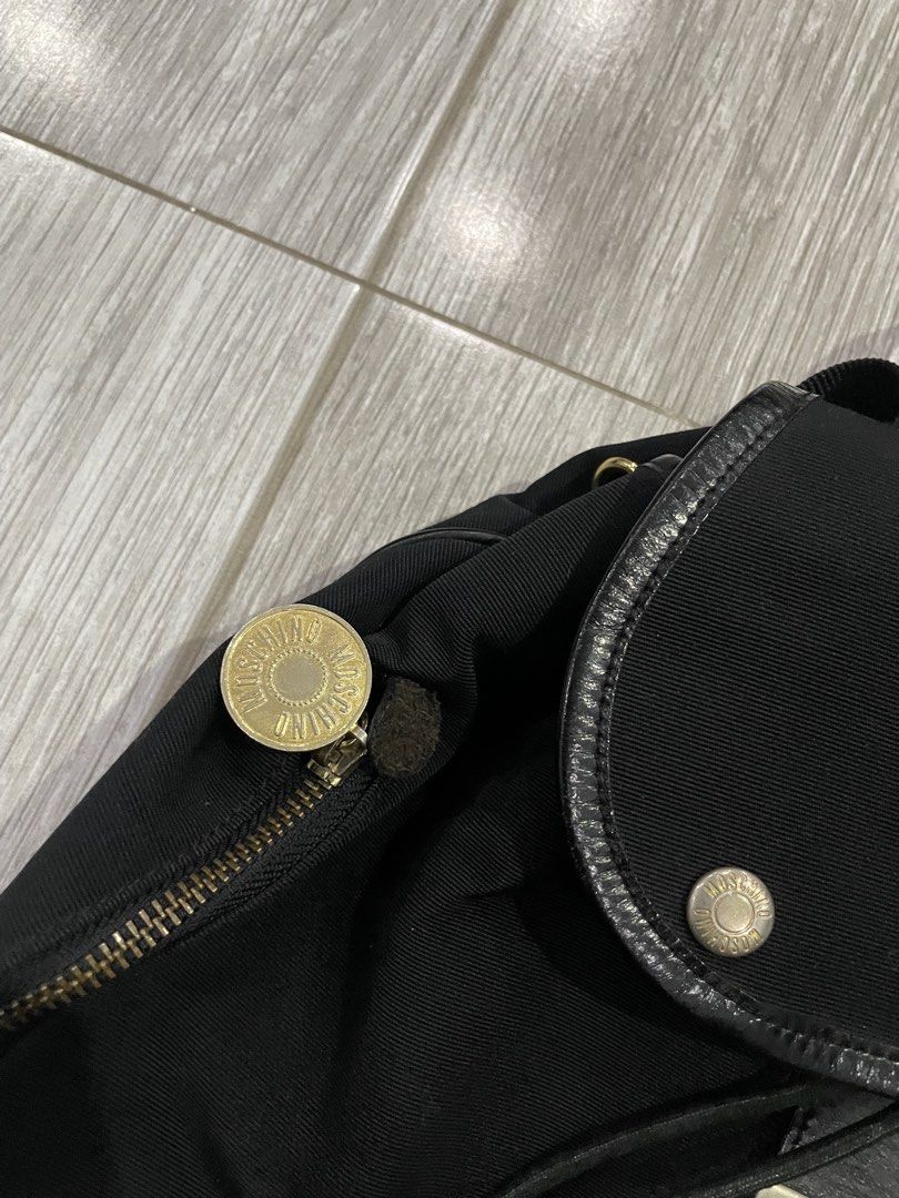 Vintage Moschino Capsule Drawstring Backpack (Category: Luxury Bags & Wallets) located in Las Pinas. Submitted by dhliacmp (Listing ID 1455488419, Image 3). Description: Vintage Moschino Capsule Drawstring Backpack In Good condition due to its age Seen sold for 300usd Selling fro only 5500 php Lots of pockets and compartments.