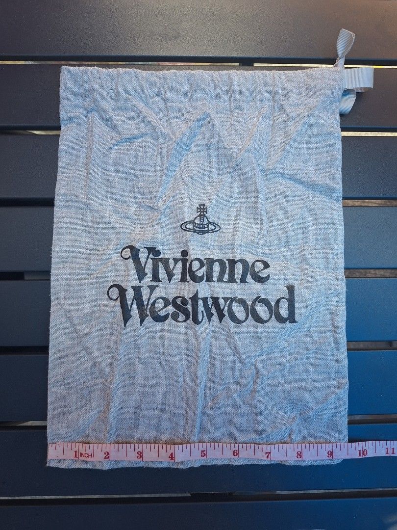 Vivienne Westwood Dust Bag (Category: Luxury Bags & Wallets) located in Sibulan. Submitted by studioxano (Listing ID 1455332582, Image 3). Description: - Authentic Vivienne Westwood dust bag - Material: Grey linen - Features iconic black orb logo and brand name print - Secure drawstring closure with ribbon tie - Ideal for storing shoes, small bags, or accessories - Approximate dimensions: 14 inches (height) x 9 inches (width).