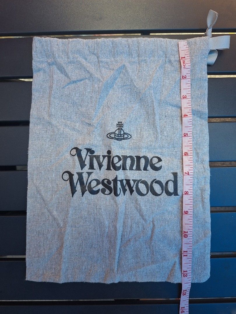 Vivienne Westwood Dust Bag (Category: Luxury Bags & Wallets) located in Sibulan. Submitted by studioxano (Listing ID 1455332582, Image 2). Description: - Authentic Vivienne Westwood dust bag - Material: Grey linen - Features iconic black orb logo and brand name print - Secure drawstring closure with ribbon tie - Ideal for storing shoes, small bags, or accessories - Approximate dimensions: 14 inches (height) x 9 inches (width).