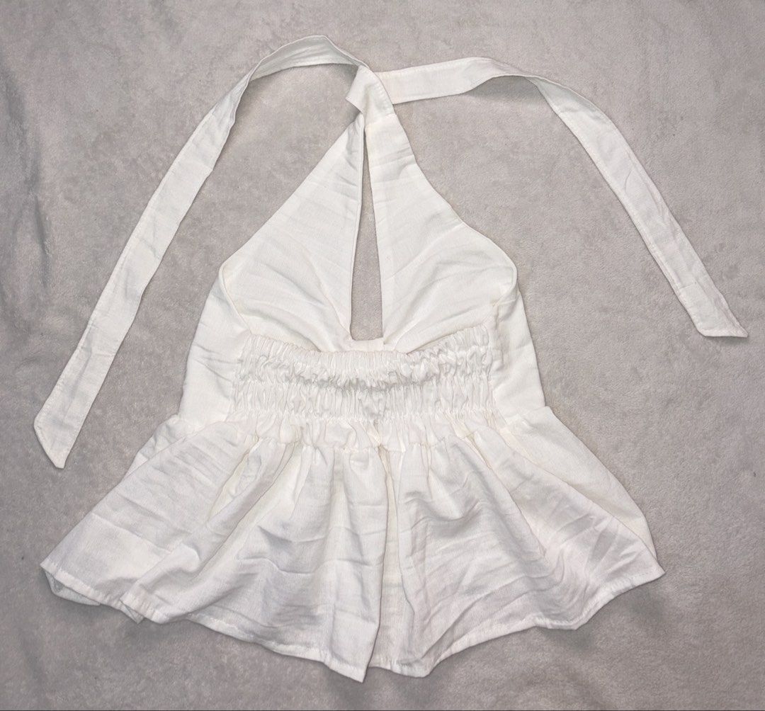 White Halter Neck Tie Back Peplum Top (Category: Sleeveless) located in Taguig. Submitted by aclarecorner (Listing ID 1455339257, Image 2). Description: Cute white halter top with gathered bust and peplum hem. Ties at neck. Linen-blend fabric. Perfect for summer or vacation..