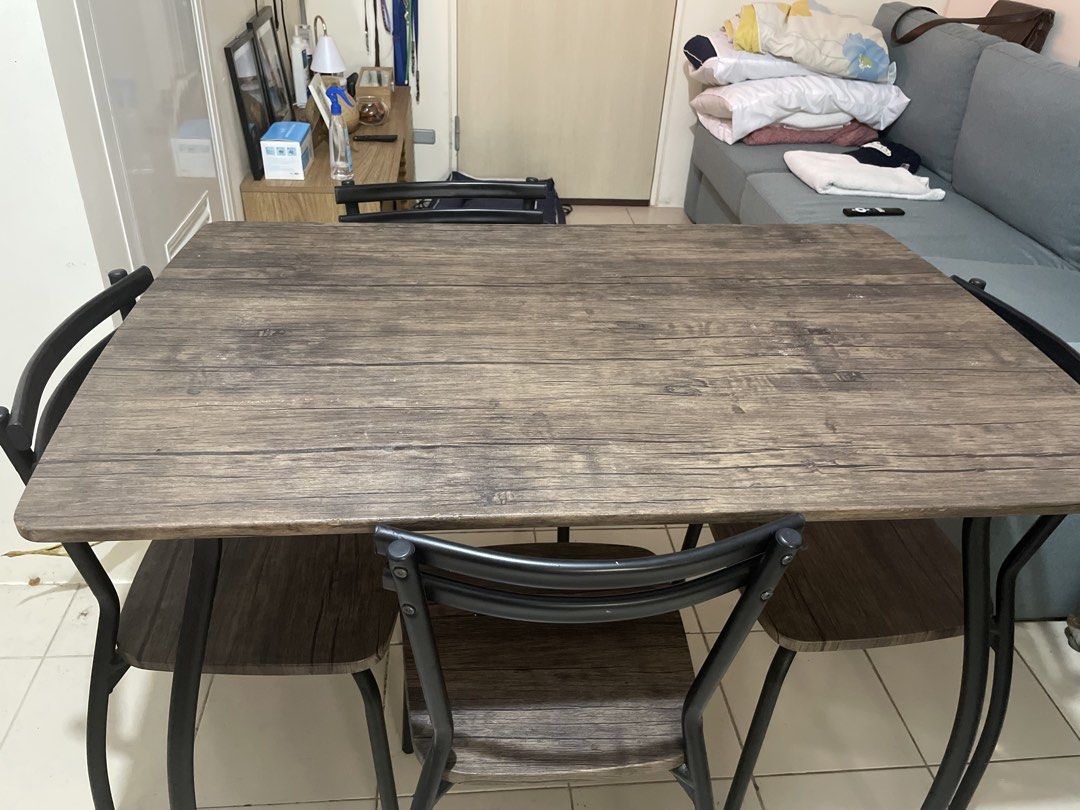 Wooden Dining Table with 4 Chairs (Category: Tables & Sets) located in Pasig City. Submitted by shaneowen.pineda (Listing ID 1455388736, Image 2). Description: - Rustic wood grain dining table - 4 chairs with black metal frames - Wood-look seats on chairs - Ideal for small spaces or kitchens - Easy to clean and maintain - Ready for its new home!.