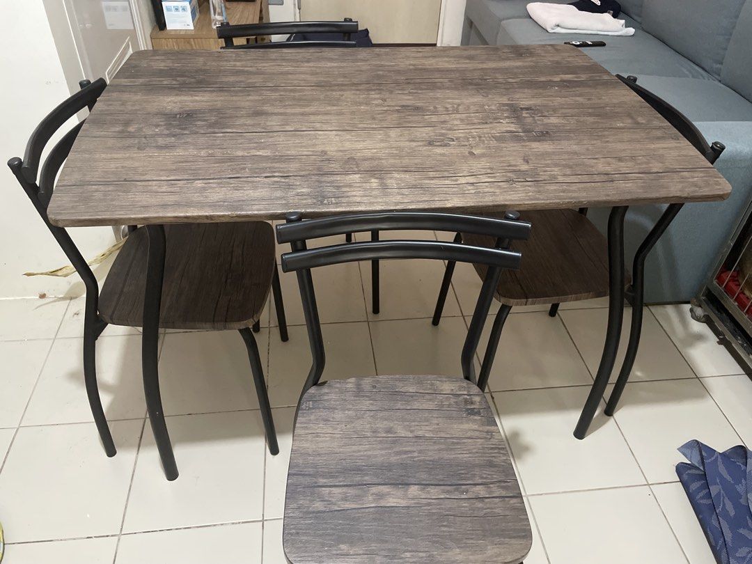 Wooden Dining Table with 4 Chairs (Category: Tables & Sets) located in Pasig City. Submitted by shaneowen.pineda (Listing ID 1455388736, Image 1). Description: - Rustic wood grain dining table - 4 chairs with black metal frames - Wood-look seats on chairs - Ideal for small spaces or kitchens - Easy to clean and maintain - Ready for its new home!.