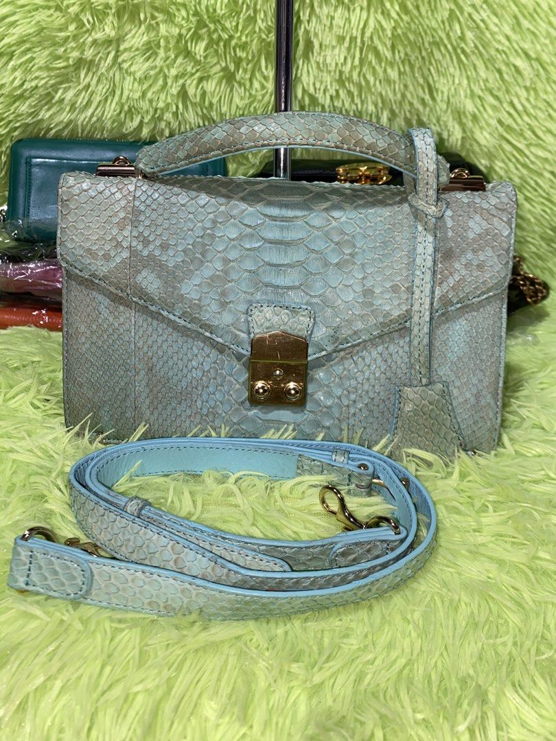 Zarmoi python sling bag (Category: Cross-body Bags) located in Davao. Submitted by ukaystuff07 (Listing ID 1455493487, Image 3). Description: Preloved from Korean box >python leather >with key >with wallet like compartment at the back >still gold hardware >issue: line mark in front metal hardware and pressed mark at the back but still the bag is sooo beautiful😍🤩.