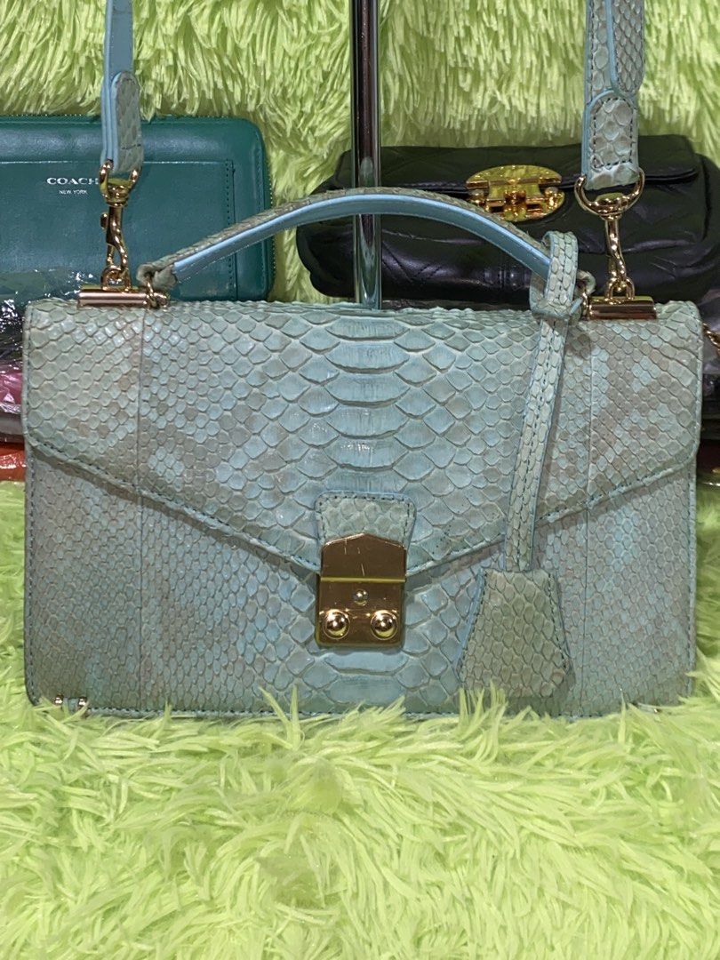Zarmoi python sling bag (Category: Cross-body Bags) located in Davao. Submitted by ukaystuff07 (Listing ID 1455493487, Image 2). Description: Preloved from Korean box >python leather >with key >with wallet like compartment at the back >still gold hardware >issue: line mark in front metal hardware and pressed mark at the back but still the bag is sooo beautiful😍🤩.