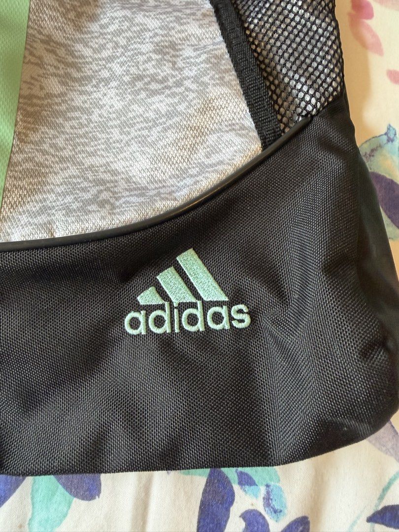 Adidas Drawstring Bag Gym Sack (Category: Backpacks) located in Taguig. Submitted by prelovedbygbby (Listing ID 1455562658, Image 2). Description: - Adidas drawstring bag - Color: Grey with mint green accents and black bottom - Features: Mesh side pockets, front zip pocket - Ideal for: Gym or everyday use - Design: Classic Adidas stripes.