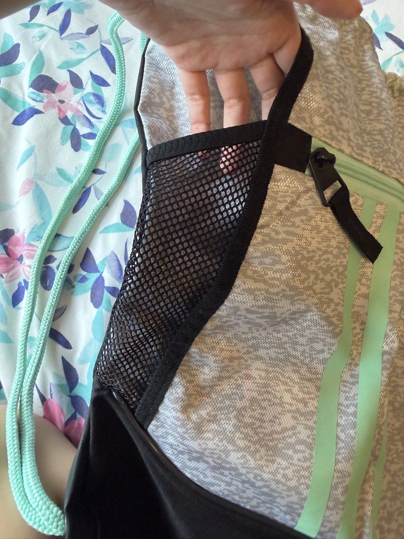 Adidas Drawstring Bag Gym Sack (Category: Backpacks) located in Taguig. Submitted by prelovedbygbby (Listing ID 1455562658, Image 3). Description: - Adidas drawstring bag - Color: Grey with mint green accents and black bottom - Features: Mesh side pockets, front zip pocket - Ideal for: Gym or everyday use - Design: Classic Adidas stripes.