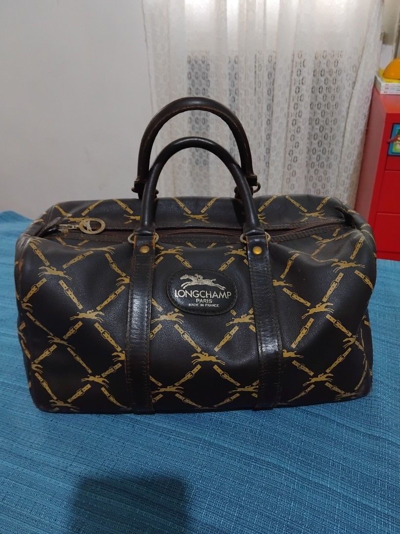 Authentic Longchamp Vintage Monogram Leather Boston Bag in 30 (Category: Luxury Bags & Wallets) located in Manila. Submitted by daronandtruffles (Listing ID 1455586008, Image 2). Description: - Vintage Longchamp satchel bag - Classic gold monogram print on dark brown leather - Genuine leather handles and trim - Secure zipper closure - Authentically made in France Material: Full grain leather inside and out Faded tag but it is Made in France Dimen