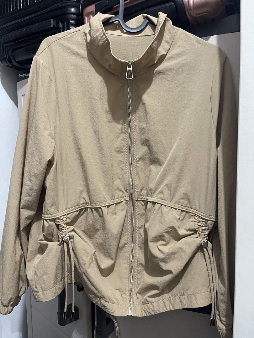 Beige Drawstring Waist Jacket with Heart Charm (Category: Coats, Jackets and Outerwear) located in Manila. Submitted by ttbbkk (Listing ID 1455600859, Image 1). Description: - Lightweight beige jacket - Zip-up front with stand collar - Elasticated cuffs and hem - Adjustable drawstring waist with cute heart charms - Ideal for layering - Easy to style.