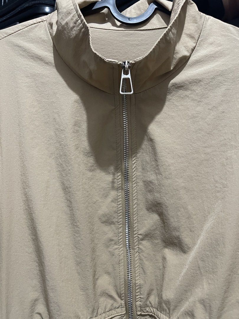 Beige Drawstring Waist Jacket with Heart Charm (Category: Coats, Jackets and Outerwear) located in Manila. Submitted by ttbbkk (Listing ID 1455600859, Image 3). Description: - Lightweight beige jacket - Zip-up front with stand collar - Elasticated cuffs and hem - Adjustable drawstring waist with cute heart charms - Ideal for layering - Easy to style.