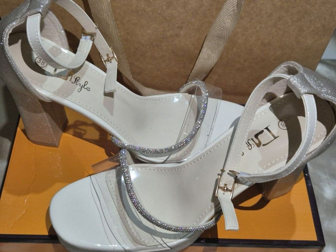 Beige High Heels - Size 38 (Category: Heels) located in Manila. Submitted by cyrillex (Listing ID 1455581375, Image 1). Description: Color: Beige with silver details Size: 38 Comes with original box Perfect for occasions I bought this for 750 pesos Condition: Brand new, never been used.