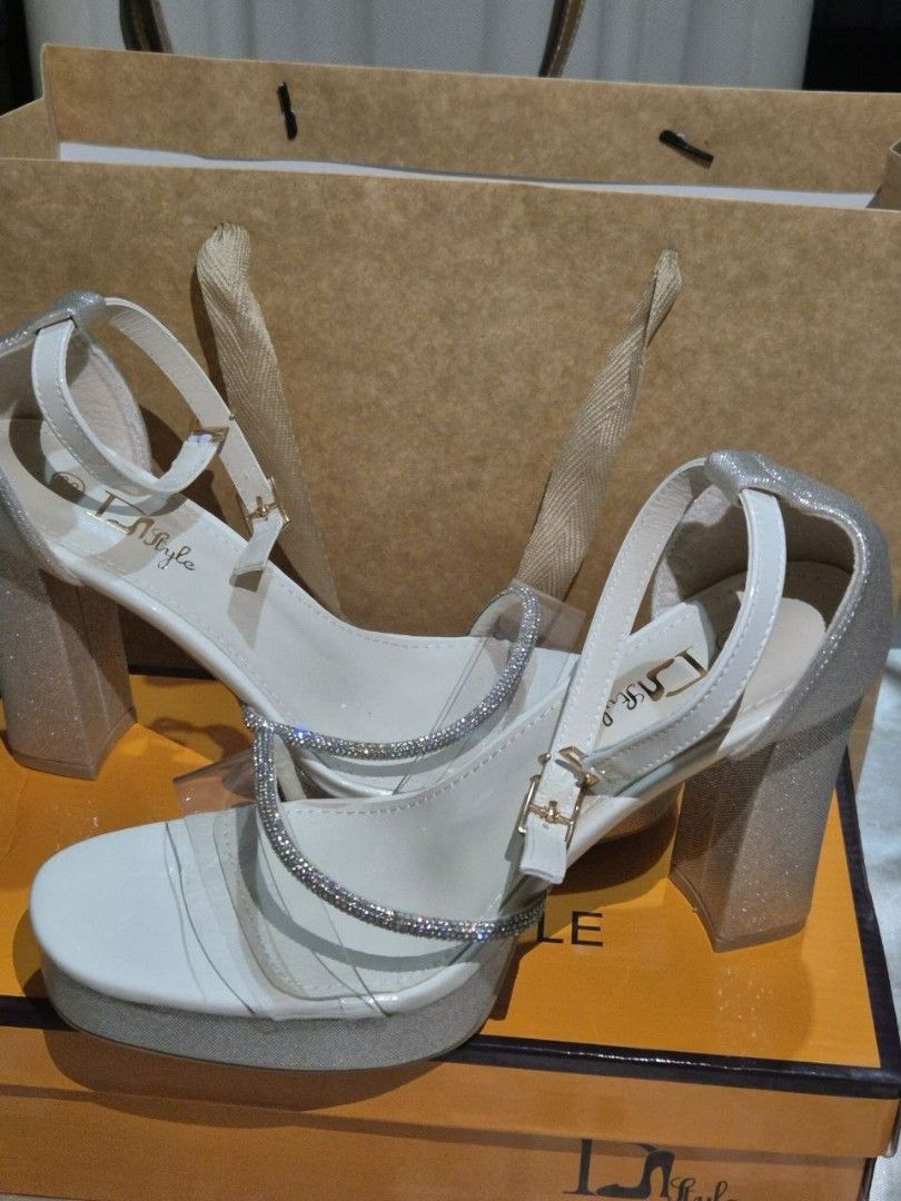 Beige High Heels - Size 38 (Category: Heels) located in Manila. Submitted by cyrillex (Listing ID 1455581375, Image 3). Description: Color: Beige with silver details Size: 38 Comes with original box Perfect for occasions I bought this for 750 pesos Condition: Brand new, never been used.