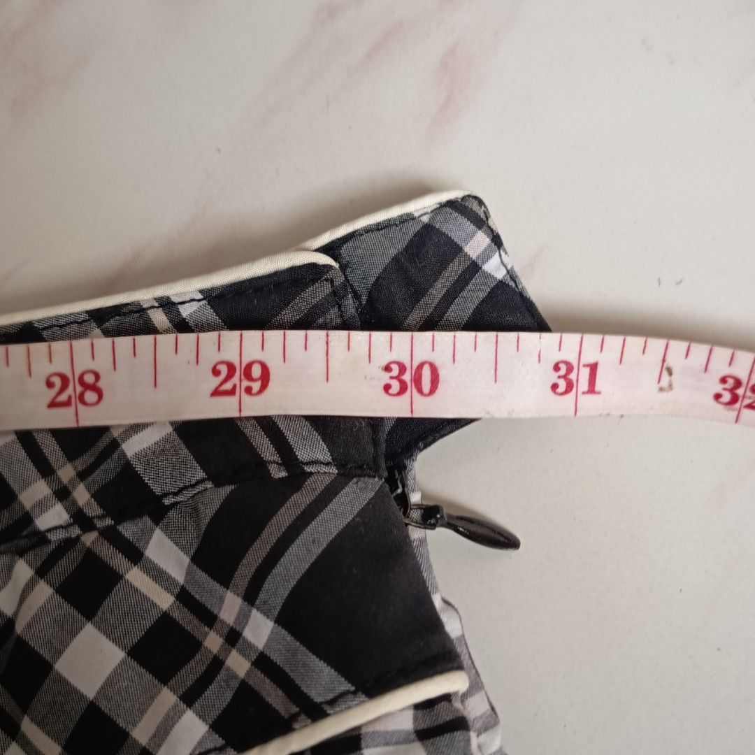 Black and White Plaid Mini Skirt (Category: Skirts) located in Davao. Submitted by lovedbyberry (Listing ID 1455659590, Image 2). Description: - Adorable black and white plaid mini skirt - Features a convenient side zipper - Stylish white trim detail on the waistband - Estimated to fit waist sizes 29-30 - Versatile for both casual and preppy looks.