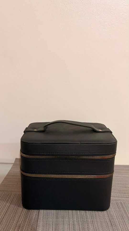 Black Makeup Vanity Case with Mirror and Zippers (Category: Makeup) located in Taguig. Submitted by styledmnl (Listing ID 1455500913, Image 3). Description: - Stylish black makeup case - Built-in mirror inside the lid - Two zippered compartments for ample storage - Convenient top handle for easy carrying - Ideal for organizing cosmetics and toiletries - Compact and travel-friendly design.