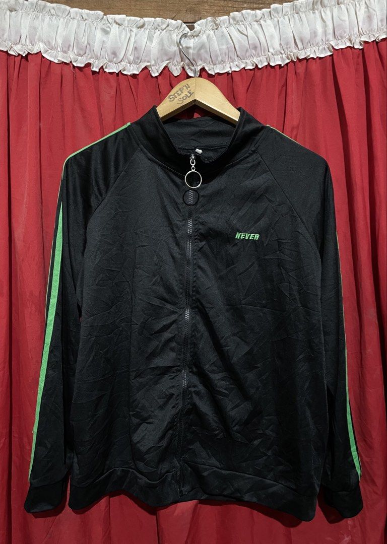 Black Track Jacket with Green Stripes (Category: Coats, Jackets and Outerwear) located in Manila. Submitted by stepsole (Listing ID 1455655976, Image 1). Description: - Sleek black track jacket - Features striking bright green stripes on sleeves - Zipper closure with a convenient ring pull - Embroidered 'NEVER' detail on the chest in green - Ideal for everyday casual wear or athletic activities.