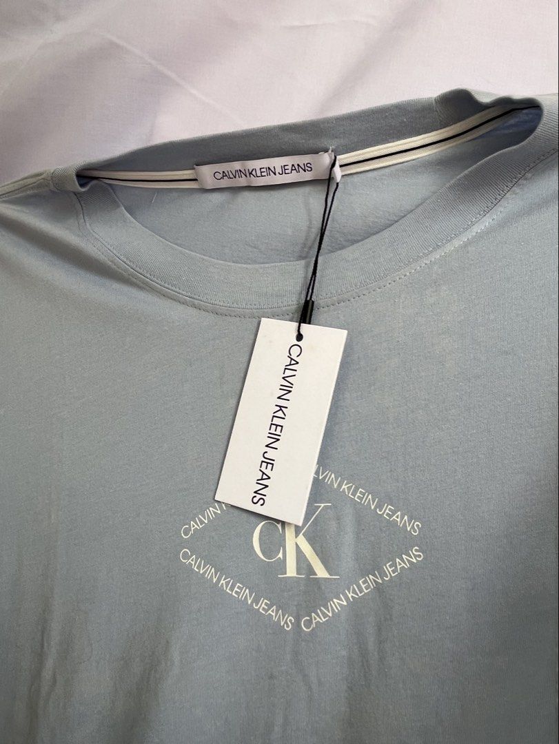 CALVIN KLEIN (Category: Tshirts & Polo Shirts ) located in Bulacan. Submitted by stacksonracks_ph (Listing ID 1390522315, Image 2). Description: Color: Powder Blue Length: 30 inches Width: 24 inches Sleeve length: 9 inches.