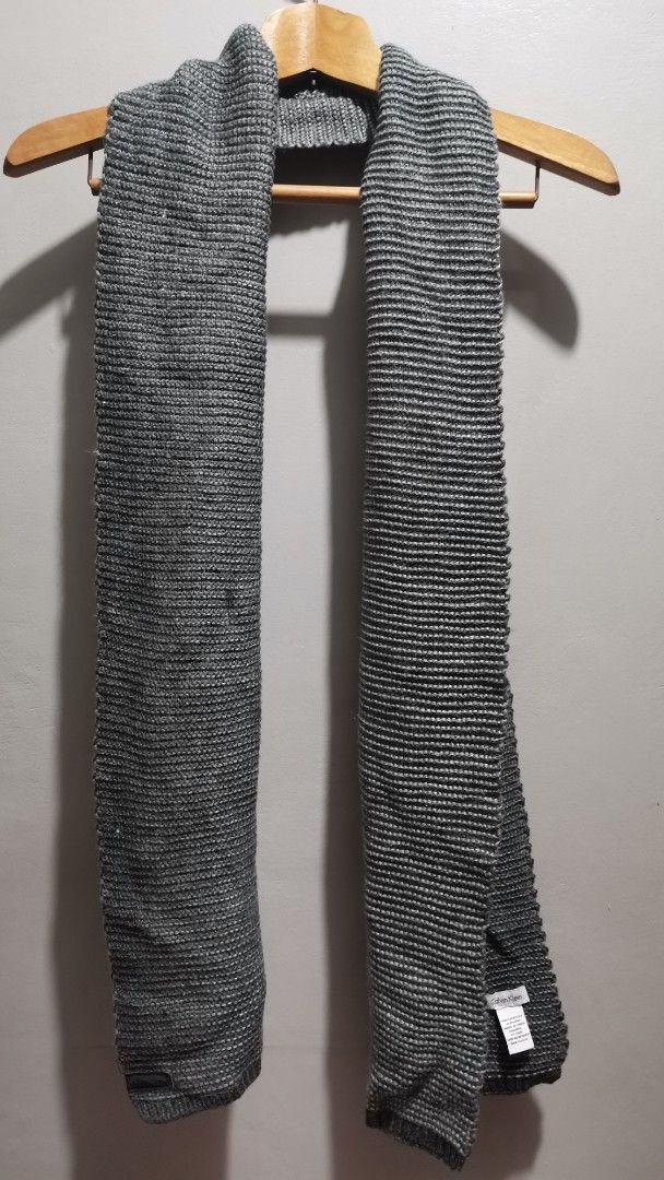 Calvin Klein Grey Knit Acrylic Scarf (Category: Scarves) located in Quezon City. Submitted by heybailey (Listing ID 1455585325, Image 1). Description: - Brand: Calvin Klein - Color: Grey - Material: 100% Acrylic - Style: Simple ribbed texture - Features: Nice length for wrapping, great for cooler weather, easy to style with various outfits..
