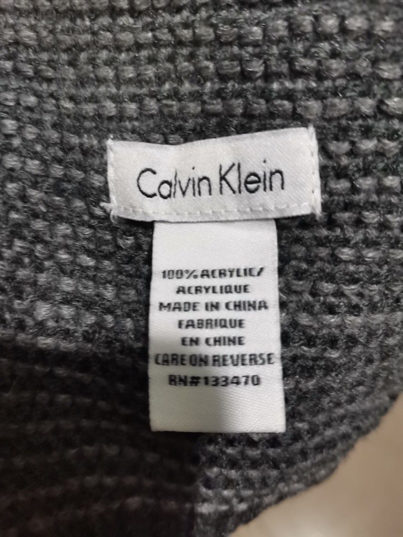 Calvin Klein Grey Knit Acrylic Scarf (Category: Scarves) located in Quezon City. Submitted by heybailey (Listing ID 1455585325, Image 2). Description: - Brand: Calvin Klein - Color: Grey - Material: 100% Acrylic - Style: Simple ribbed texture - Features: Nice length for wrapping, great for cooler weather, easy to style with various outfits..