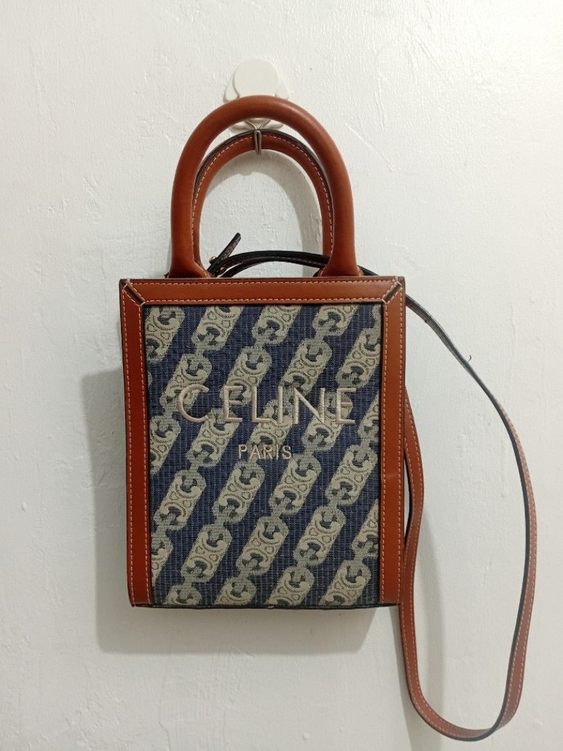 Celine Triomphe Canvas Mini Vertical Tote Bag (Category: Luxury Bags & Wallets) located in Manila. Submitted by eriiicaspage (Listing ID 1455586072, Image 1). Description: PreOwned LikeNew Lightly Used Celine Mini Canvas Leather trim Vertical Tote -Small Compact Size - Signature Triomphe canvas with brown leather trim - Top handles and detachable shoulder strap - Elegant gold hardware - Versatile for everyday or evening use - Spacious interior fo