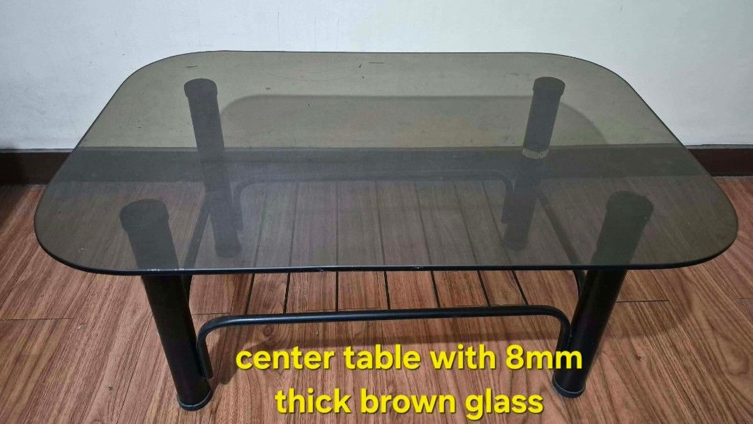 Center Table with 8mm Thick Brown Glass (Category: Tables & Sets) located in San Juan City. Submitted by dgoch27 (Listing ID 1455621552, Image 1). Description: - Sleek, modern center table - Thick, 8mm brown glass top - Sturdy black metal frame - Perfect for living rooms or as a coffee table - Selling because of redecoration.